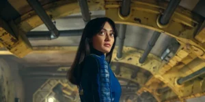 Ella Purnell turns around standing underneath an arc in Prime Video series Fallout