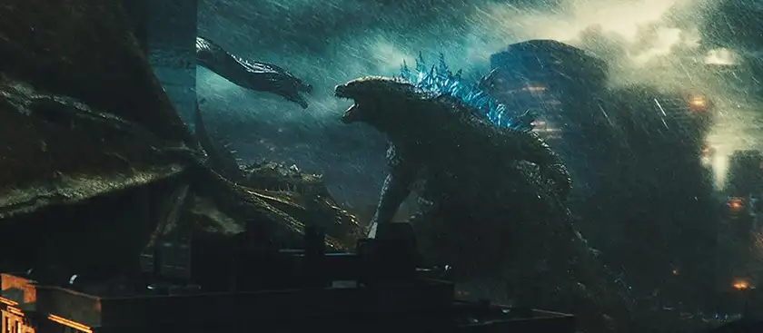 Godzilla and Kong face each other in the rain in Godzilla: King of the Monsters, one of the Monsterverse movies ranked from worst to best