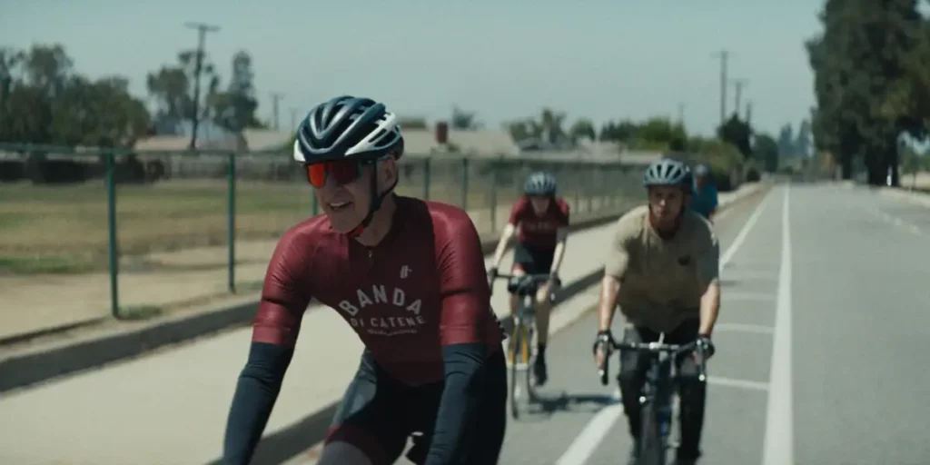 Matthew Modine and his group of cyslists cycle on the road in the movie Hard Miles