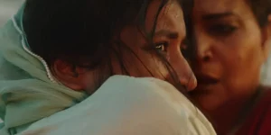 Two women stand close to each other in the film In Flames