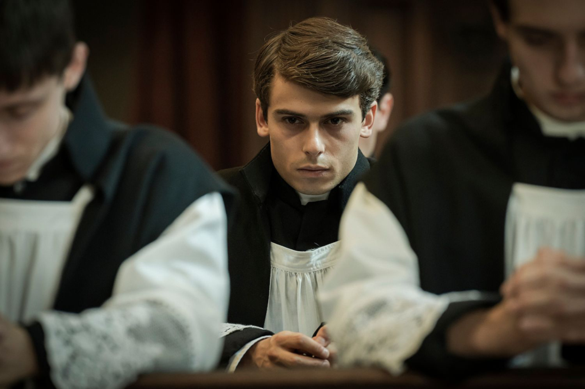 A young man wears catholic clothes in the film Kidnapped, whose director, Marco Bellocchio, we interview
