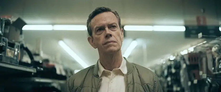 Dylan Baker looks up while standing in a store aisle in the film Laroy Texas