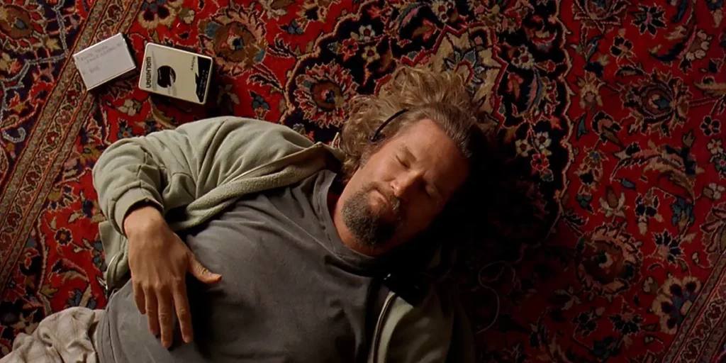 Jeff Bridges lies on a rug in The Big Lebowski