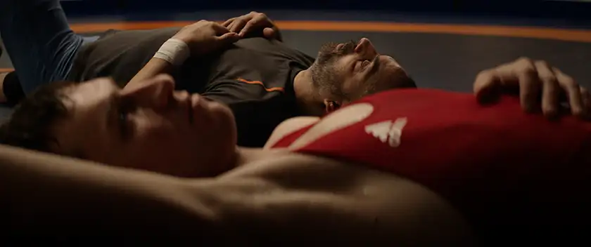 Two characters lie on the ground next to each other in the film Opponent, from director Milad Alami, who spoke to Loud and Clear Reviews in an interview