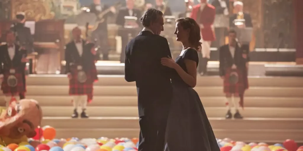 Two people dance with balloons on the floor in the film Phantom Thread