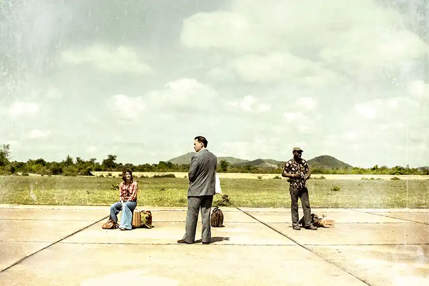 Three people stand apart from one another with suitcases in the movie RENDEZ-VOUS AVEC POL POT, one of the 20 films to watch at the 2024 Cannes film festival according to Loud and Clear Reviews