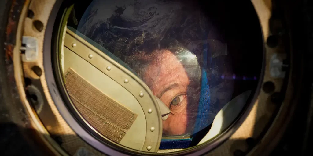Cady Coleman looking out of the Soyuz in the film Space: The Longest Goodbye