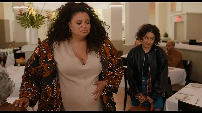 Michelle Buteau and Ilana Glazer are leaving a restaurant in a still from the film Babes