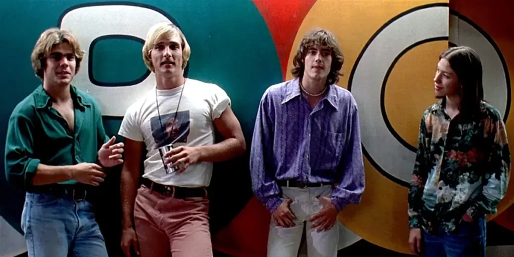 Teenagers stand in front of a colorful wall in Dazed and Confused