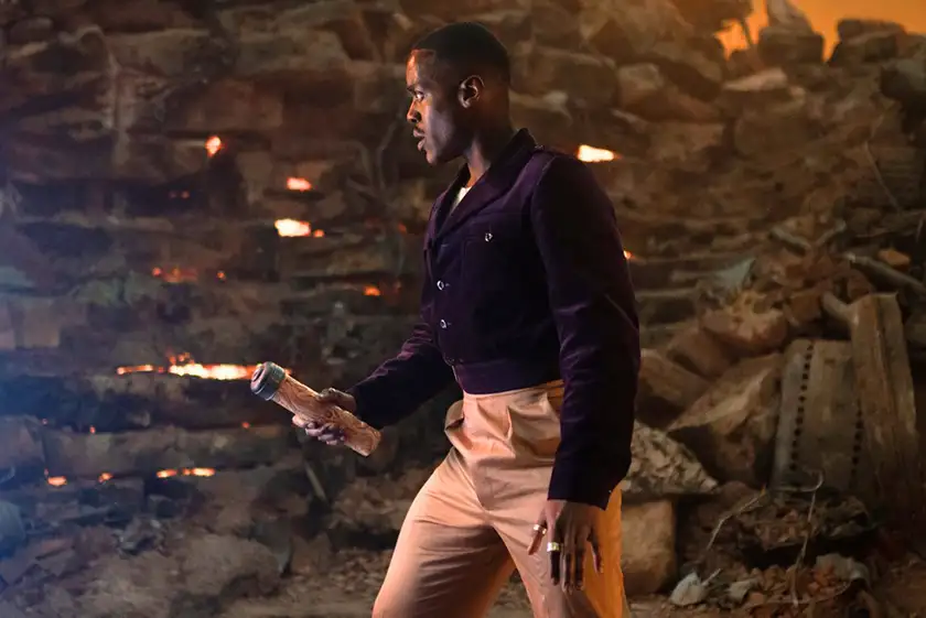 Ncuti Gatwa holds a torch with fire as The Doctor in "Boom," Season 1 Episode 3 of Doctor Who (2024)