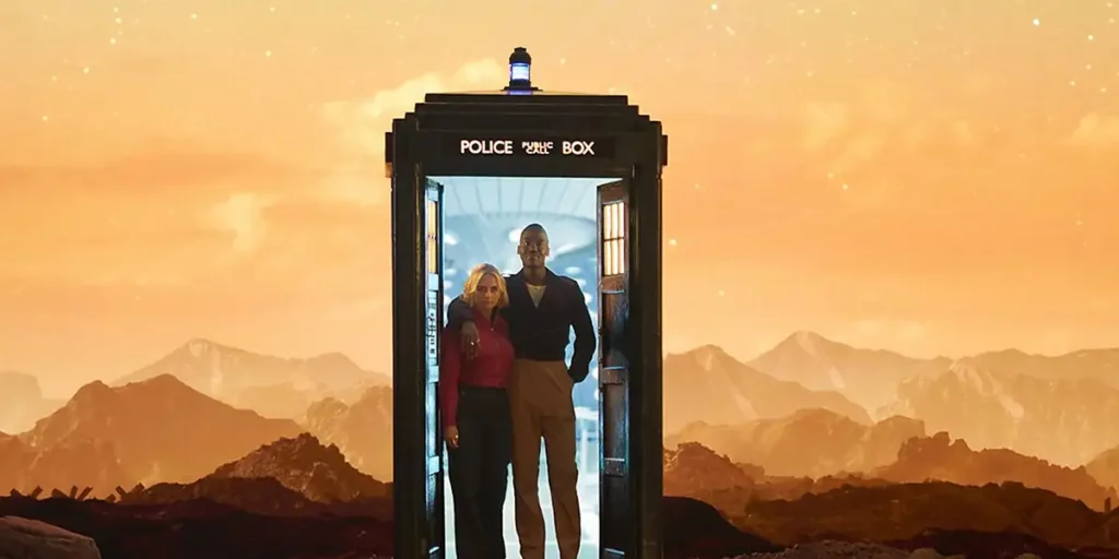 Millie Gibson and Ncuti Gatwa are inside the Doctor Who phone box with the doors open and orange sky behind them in "Boom," Season 1 Episode 3 of Doctor Who (2024)