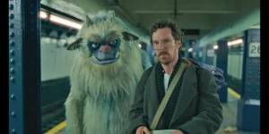 Benedict Cumberbatch is in the underground with a blue monster next to him in Eric