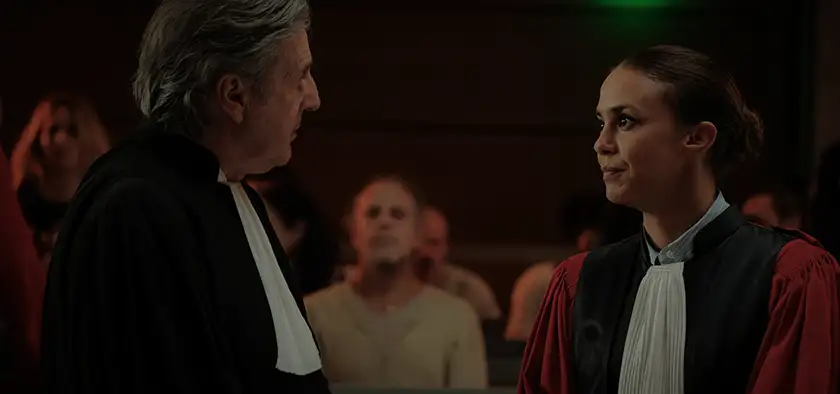 Two lawyers look at each other in the courtroom in a scene from the Daniel Auteuil film Le Fil (An Ordinary Case), featured in the Loud and Clear interview 