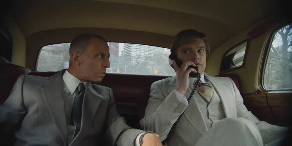 Two businessmen are in a car in the film The Apprentice