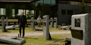 A man stands in the middle of a destroyed cemetery in the film The Shrouds