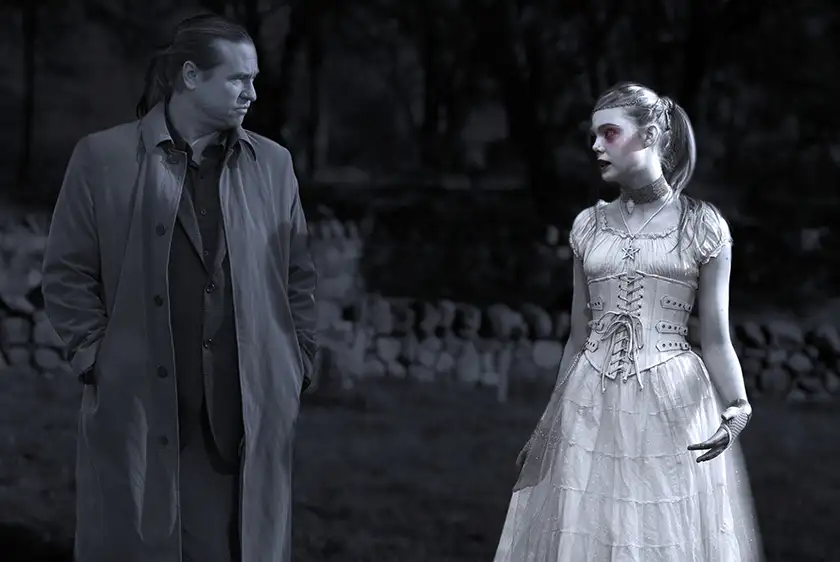 Two vampires, a man and a girl, look at each other in the film Twixt