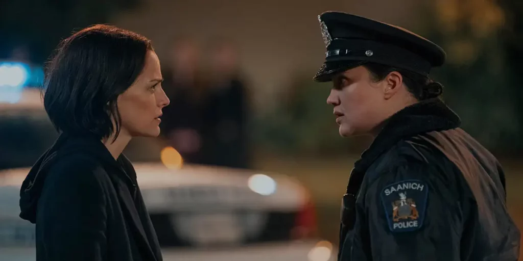 A woman and a policewoman are face to face at night in Episode 6 of Under the Bridge