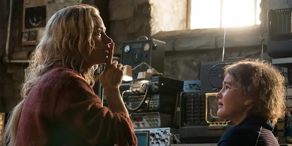 A woman gestures to a child to be quiet in the 2018 film A Quiet Place