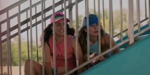 Two women look through a barrier in the film Adult Best Friend, in a photo featured on the Loud and Clear interview with Delaney Buffett and Katie Corwin