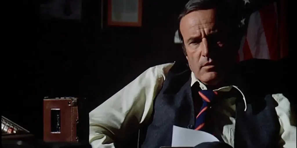 A man sits behind a desk holding a paper in Episode 1 of The Bionic Woman (1976)