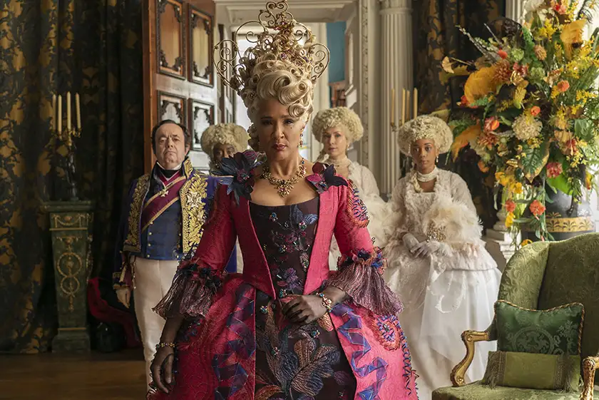 Queen Charlotte walks with her court behind her inside the palace in season 3 part 2 of Bridgerton