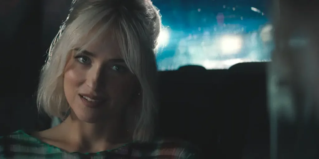 Dakota Johnson smiles sitting in the back of a cab in the film Daddio