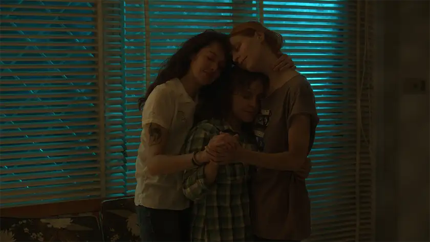 Two women and a child hug in the film Don’t You Let Me Go, in a still used in the Loud and Clear interview with director Leticia Jorge