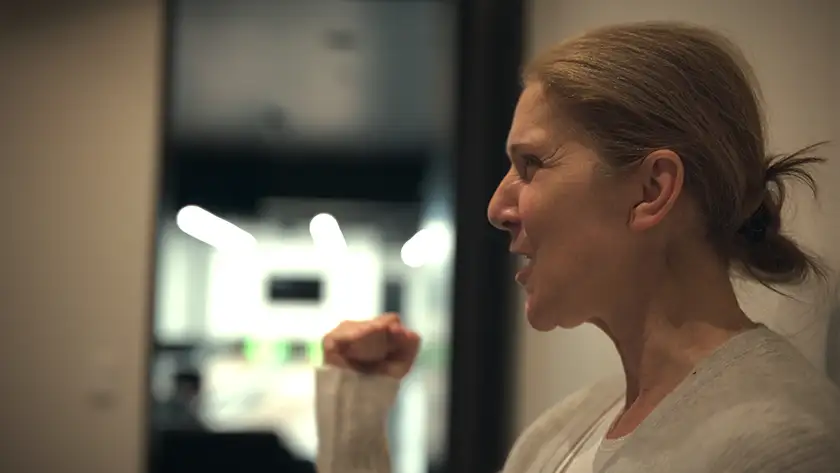 Céline Dion makes a fist with her hand in a sign of strength in the 2024 film I Am: Celine Dion