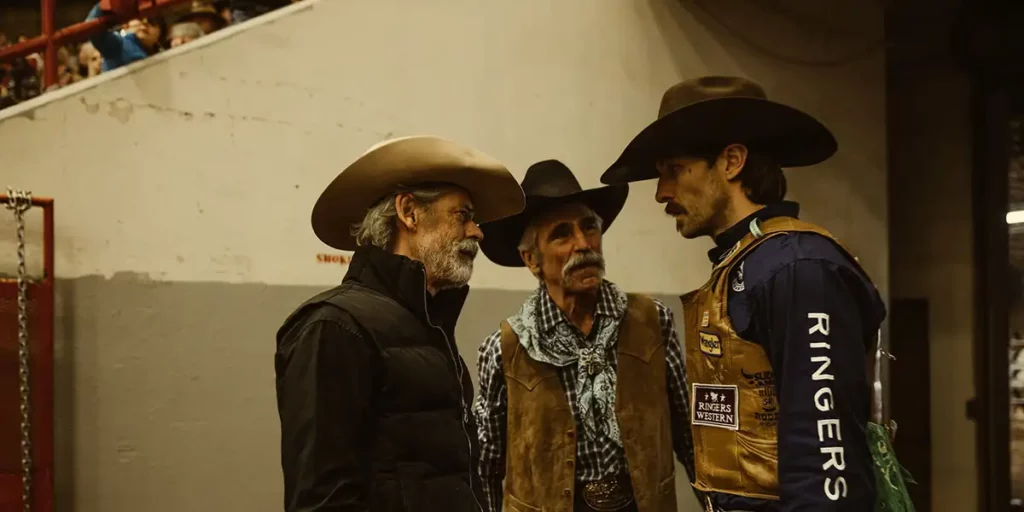 Three cowboys talk to each other in a circle in a still from the film Ride