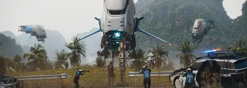 Three small futuristic planes are attacking people and the police is on the ground shooting at them in The Creator, in a still featured in an article about how film studios can save movie theaters
