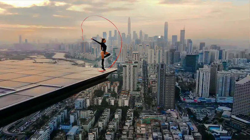 A woman does acrobatics on a dangerously high building in China in the film Skywalkers: A Love Story