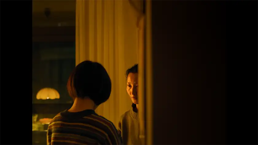 Two women stand opposite each other in a still from the film Some Rain Must Fall, used in an interview with director Qiu Yang