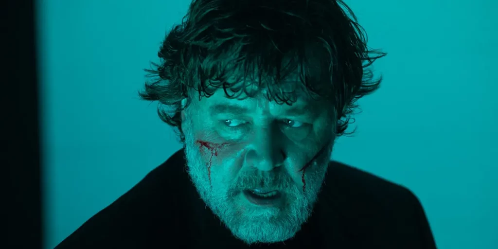 Russell Crowe has two cuts on his cheeks in a photo from the 2024 film The Exorcism