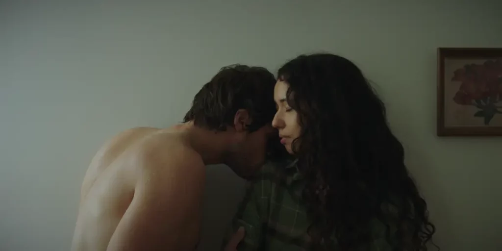 A naked man kisses a woman on a shoulder in the film This Closeness
