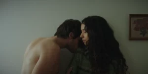 A naked man kisses a woman on a shoulder in the film This Closeness