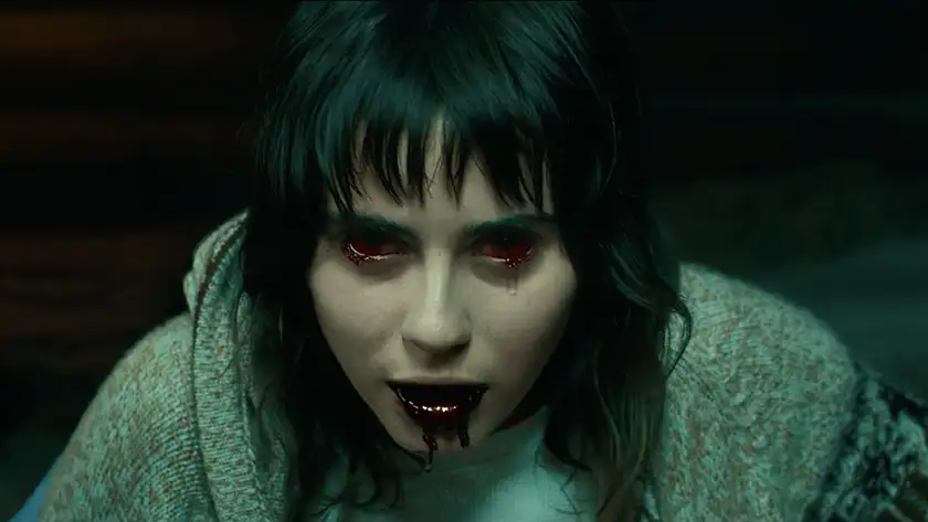A woman has bloodshot eyes and dripping blood from her mouth in the film Trim Season