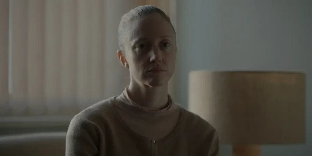 A woman wears a dark yellow top in the film What Remains