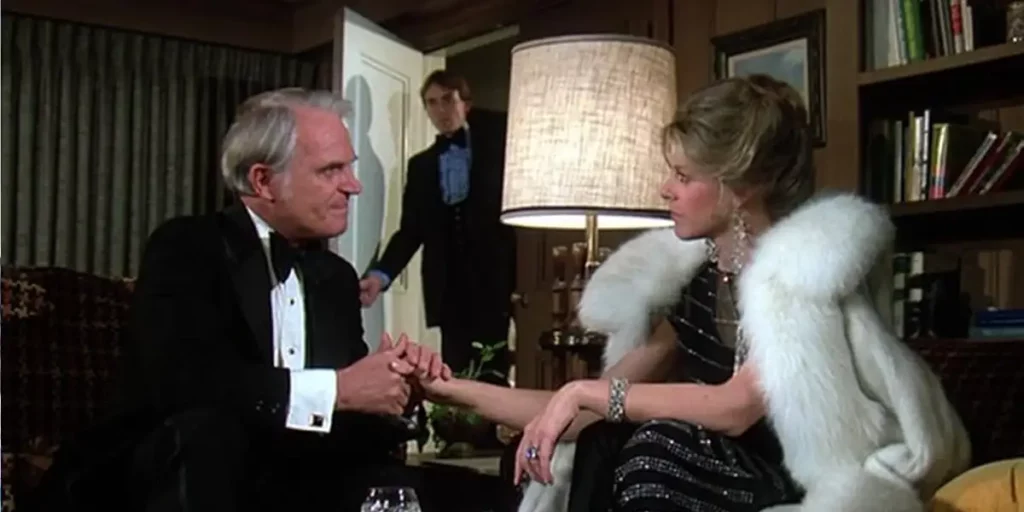 A man and a woman sit down, wearing smart clothes, in episode 2 of The Bionic Woman (1976)