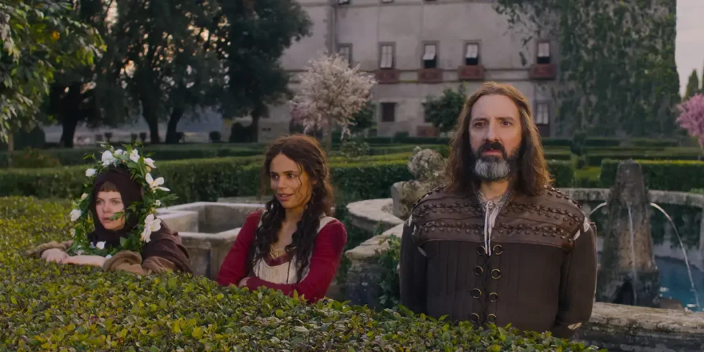 Three people emerge from behind some bushes in Netflix's The Decameron