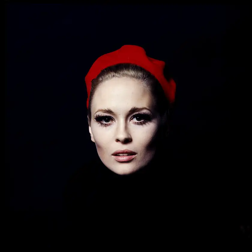 Faye Dunaway's face with a red headband floats in the middle of a black square photo, in a photo taken by Jerry Schatzberg, property of HBO, used in the 2024 documentary