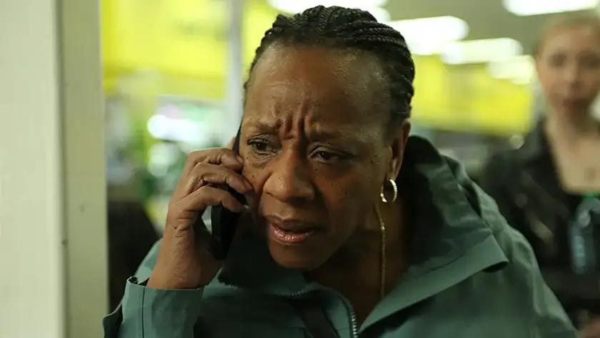 A woman is on the phone in a still from the film Hard Truths