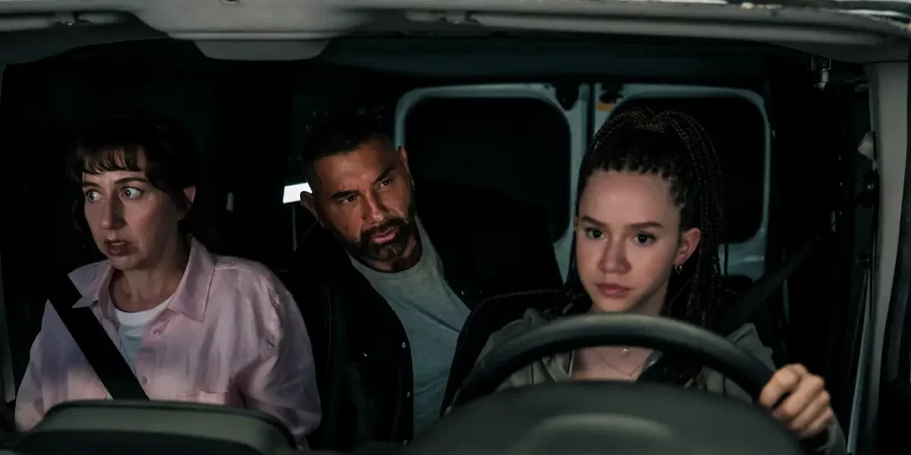 Three characters in a car in the movie My Spy: The Eternal City
