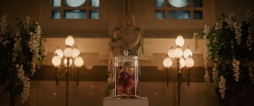 A human heart is inside a glass container in a church in the 2024 film Ababouiné