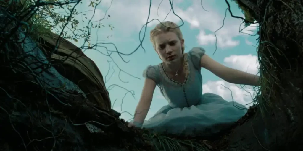 Alice looks down the rabbit hole in Alice in Wonderland (2010)