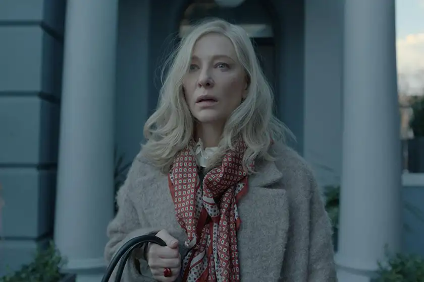 Cate Blanchett looks ahead in shock, wearing a brown coat and holding a handbag, in the Alfonso Cuarón series Disclaimer