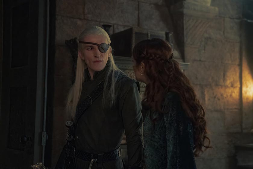 A man with a patch on his eye looks at a woman with red hair in Season 2 Episode 8, the season 2 finale, of House of the Dragon