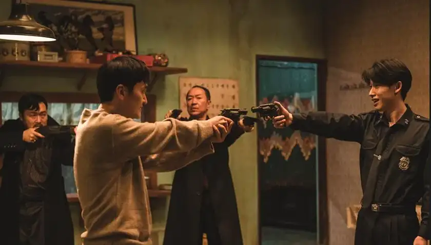 four people point guns at one another in Everyone is Waiting for the Man, one of the shorts from the 2024 crime anthology The Killers