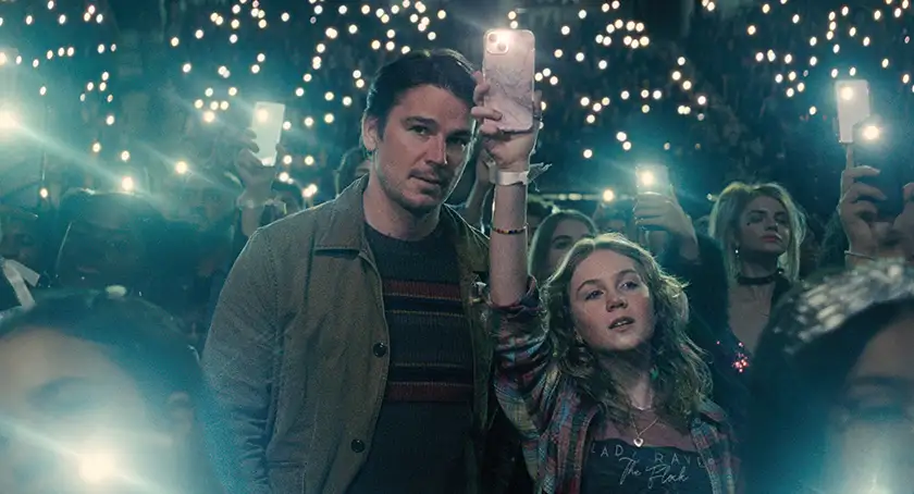 JOSH HARTNETT as Cooper and ARIEL DONOGHUE as Riley in M. Night Shyamalan’s Trap, which is inspired by a true story