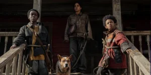 A family stands outside a house leaning on a wooden staircase in Never Let Go