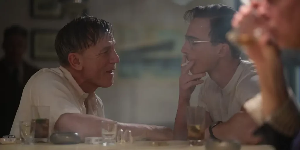 Daniel Craig flirts with a man at a bar in a still from the Guadagnino movie Queer